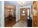 Inviting entryway featuring a decorative glass door and tiled floor leading into a dining area at 1471 S Frog Pond Ct, Greenfield, IN 46140