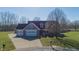 Charming home with a three-car garage, well-manicured lawn, and inviting curb appeal at 1471 S Frog Pond Ct, Greenfield, IN 46140