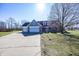Charming home exterior with a three-car garage and long driveway at 1471 S Frog Pond Ct, Greenfield, IN 46140