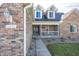 Inviting front porch with seating, brick facade, and well-kept landscaping enhancing curb appeal at 1471 S Frog Pond Ct, Greenfield, IN 46140