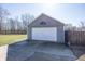 View of the exterior garage featuring two car spaces, a basketball hoop, and a driveway at 1471 S Frog Pond Ct, Greenfield, IN 46140