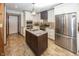 Updated kitchen with stainless steel appliances, a central island, and sleek white cabinetry at 1471 S Frog Pond Ct, Greenfield, IN 46140