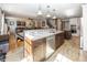 Open kitchen with a large central island and seamless flow into the living area at 1471 S Frog Pond Ct, Greenfield, IN 46140