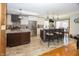 Well-lit kitchen featuring stainless steel appliances, a central island, and ample cabinet space at 1471 S Frog Pond Ct, Greenfield, IN 46140