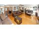 Open-concept living room with hardwood floors, a fireplace, and seamless flow into the kitchen at 1471 S Frog Pond Ct, Greenfield, IN 46140