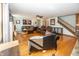 Spacious living room boasting hardwood floors, a fireplace, and staircase to the upper level at 1471 S Frog Pond Ct, Greenfield, IN 46140