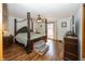 Spacious main bedroom with a beautiful four-poster bed and outdoor access at 1471 S Frog Pond Ct, Greenfield, IN 46140