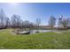 Picturesque pond with docks, serene water, and lush green grass at 1471 S Frog Pond Ct, Greenfield, IN 46140