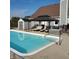 Backyard pool with pergola, lounge chairs and hot tub, creating a perfect relaxation space at 1471 S Frog Pond Ct, Greenfield, IN 46140