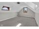 Bedroom has carpet floors, neutral paint, windows, and angled ceilings at 1707 Rocky Ford Rd, Columbus, IN 47203