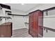 Walk-in closet with custom organizers, dark wood, and plenty of storage space at 1707 Rocky Ford Rd, Columbus, IN 47203