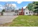 Charming home with a red front door, brick accents, and a spacious two-car attached garage at 1707 Rocky Ford Rd, Columbus, IN 47203
