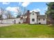 White two-story home featuring a red brick chimney and an attached two-car garage at 1707 Rocky Ford Rd, Columbus, IN 47203