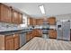 Modern kitchen with stainless steel appliances, wood cabinets, and stylish backsplash at 1707 Rocky Ford Rd, Columbus, IN 47203