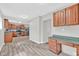 Bright kitchen and eating area featuring stainless steel appliances, wood cabinets, and modern flooring at 1707 Rocky Ford Rd, Columbus, IN 47203