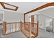 Spacious landing with wood trim, beamed ceiling, carpet flooring, and open access to adjacent rooms at 1707 Rocky Ford Rd, Columbus, IN 47203