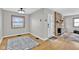 Inviting living room featuring a stone fireplace, hardwood floors, and natural light from the window at 1707 Rocky Ford Rd, Columbus, IN 47203