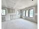 Bright unfinished bedroom with natural light from three windows and recessed lighting at 20598 Chatham Creek Dr, Westfield, IN 46074