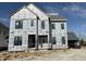 New construction home featuring black window frames and wrapped in styrofoam insulation under a cloudy, blue sky at 20598 Chatham Creek Dr, Westfield, IN 46074