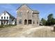 New construction home featuring a brick facade, arched entryway and black window frames at 20598 Chatham Creek Dr, Westfield, IN 46074