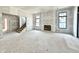 Unfinished living room area featuring a fireplace, large windows and staircase to the upper floor at 20598 Chatham Creek Dr, Westfield, IN 46074