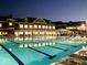 A lap swimming pool at night, adjacent to a clubhouse, with plenty of room for lounging and relaxing at 20598 Chatham Creek Dr, Westfield, IN 46074