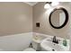 Cozy bathroom with a classic round mirror, white wainscoting, and traditional fixtures at 2180 Olympia Dr, Franklin, IN 46131