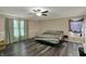 A cozy bedroom features hardwood floors, a ceiling fan, and natural light from the window at 2180 Olympia Dr, Franklin, IN 46131