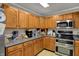 Charming kitchen featuring wood cabinets, stainless steel appliances, and sleek countertops at 2180 Olympia Dr, Franklin, IN 46131
