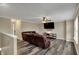 Open living room with wood floors, ceiling fan, and a leather reclining sofa at 2180 Olympia Dr, Franklin, IN 46131