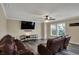 Inviting living room with hardwood floors, ceiling fan, and a large screen TV at 2180 Olympia Dr, Franklin, IN 46131