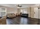 Bright living room with hardwood floors, fan, sofas, and natural lighting, creating a cozy atmosphere at 2180 Olympia Dr, Franklin, IN 46131