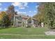 Spacious backyard showcasing the home's exterior, featuring a lush lawn and a brick outdoor fireplace at 2872 Jeremy Ct, Carmel, IN 46033