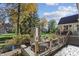 The home's stone outdoor fireplace creates an inviting outdoor living area overlooking the backyard at 2872 Jeremy Ct, Carmel, IN 46033