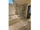 Elegant bathroom featuring a soaking tub and walk-in shower with glass door at 2872 Jeremy Ct, Carmel, IN 46033