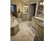 Spacious bathroom with dual vanities, a soaking tub, and neutral-toned tile at 2872 Jeremy Ct, Carmel, IN 46033