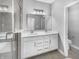 Bright bathroom features a double vanity with white cabinetry, quartz countertops, and a glass-enclosed shower at 3124 Sharon Cir, Brownsburg, IN 46112