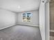 Cozy bedroom with soft carpet, ample natural light from a large window, and neutral paint at 3124 Sharon Cir, Brownsburg, IN 46112