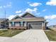 Charming gray home featuring a two-car garage, brick accents, and a well-manicured lawn at 3124 Sharon Cir, Brownsburg, IN 46112