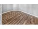 Spacious room with wood floors, white trim, and neutral walls, offering a versatile space at 3124 Sharon Cir, Brownsburg, IN 46112