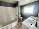 Bathroom featuring double sinks, tiled floors, and a shower/tub combination at 316 W 6Th St, Anderson, IN 46016