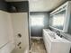 Bathroom featuring double sinks, tiled floors, shower/tub combination, and a window at 316 W 6Th St, Anderson, IN 46016