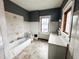 Bathroom featuring a tub, sink, and window for natural light at 316 W 6Th St, Anderson, IN 46016