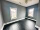 Bright bedroom with newly refinished floors, two windows, and a ceiling fan at 316 W 6Th St, Anderson, IN 46016