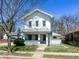 Charming two-story home with a covered front porch and white exterior paint in a residential neighborhood at 316 W 6Th St, Anderson, IN 46016