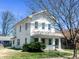 Charming two-story home with a covered front porch and white exterior paint in a residential neighborhood at 316 W 6Th St, Anderson, IN 46016