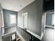 Hallway featuring black wood floors and a white banister at 316 W 6Th St, Anderson, IN 46016