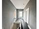 Hallway featuring black wood floors and a white banister at 316 W 6Th St, Anderson, IN 46016