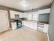 Spacious kitchen featuring white cabinets, a blue range, neutral countertops, and tile flooring at 316 W 6Th St, Anderson, IN 46016
