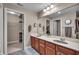Bathroom featuring dual vanity sinks and access to walk-in closet at 350 N Meridian St # 610, Indianapolis, IN 46204